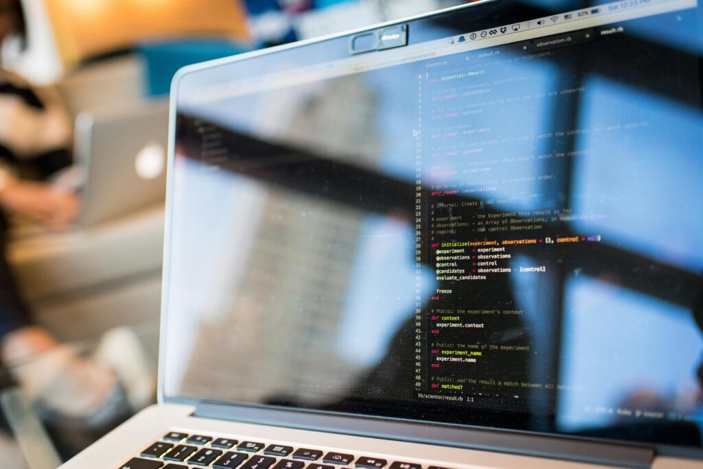 pexels-photo-1181271-1181271 Laptop displaying code with reflection, perfect for tech and programming themes.